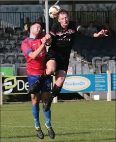  ??  ?? Mark Rossiter of St. Leonards gets his head to the ball ahead of Robbie Staples of Curracloe United.