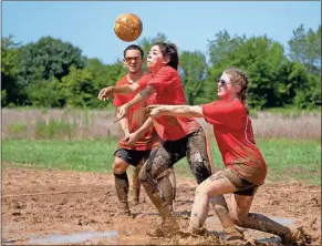  ?? Tim Godbee ?? Teammates for First Bank work together to return the ball across the net.