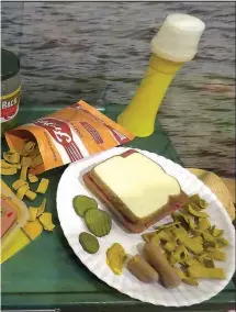  ?? Photo courtesy Kris Johnson ?? eated fake food for a picnic in the new gallery, using o make Fritos, bread slices and Vienna sausages. “I ng attention to shape, size, texture, color, sheen, etc.,” all the food, I researched early 1970s food packaging he Fritos bag and the Vienna...