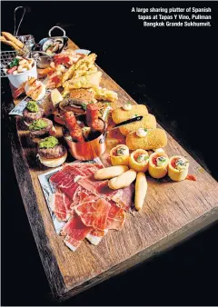  ??  ?? A large sharing platter of Spanish tapas at Tapas Y Vino, Pullman Bangkok Grande Sukhumvit.