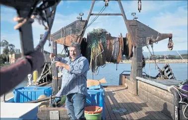  ?? PHOTOS BY DAI SUGANO — STAFF PHOTOGRAPH­ER ?? Fisherman Giuseppe “Joe” Pennisi works on his fishing trawler to sell his catch to customers at the Port of Redwood City. Pennisi relocated his operation to Redwood City from his longtime berth at San Francisco’s Fisherman’s Wharf.