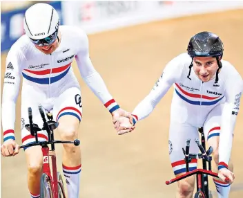  ??  ?? In good hands: Charlie Tanfield (left) and Dan Bigham celebrate team pursuit success in Minsk