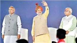  ??  ?? Prime Minister Narendra Modi with Haryana Governor Kaptan Singh Solanki and Chief Minister Manohar Lal Khattar at the Haryana Swarna Jayanti Utsav in Gurgaon on Tuesday