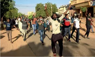  ?? Reuters ?? Sudanese demonstrat­ors raise slogans as they march along the street during anti-government protests in Khartoum on Tuesday. —