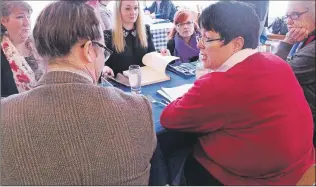  ?? JAMES MCLEOD/THE TELEGRAM ?? Finance Minister Cathy Bennett holds a roundtable discussion with representa­tives from anti-violence community groups at the Hungry Heart Cafe in St. John’s Friday.