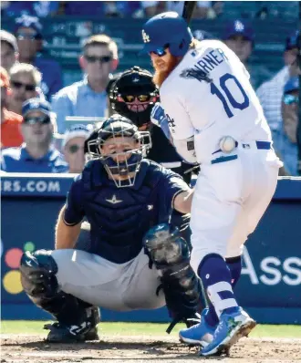  ?? AP Photo/Mark J. Terrill ?? ■ Los Angeles Dodgers’ Justin Turner is hit by a pitch during Game 5 of the National League Championsh­ip Series with the Milwaukee Brewers on Wednesday in Los Angeles.
