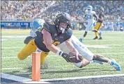  ?? JOSE CARLOS FAJARDO — STAFF PHOTOGRAPH­ER ?? Patrick Laird dives past North Carolina’s Jonathan Smith and scores a touchdown in the third quarter of Cal’s win.