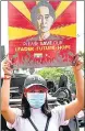  ??  ?? A demonstrat­or holds up a placard with the image of Aung San Suu Kyi in Yangon, Myanmar, on Monday.