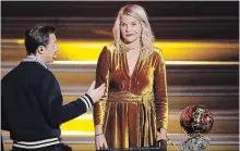  ?? CHRISTOPHE ENA THE ASSOCIATED PRESS ?? French DJ Martin Solveig talks to Olympique Lyonnais' Ada Hegerberg, of Norway, during the Ballon d'Or award ceremony in Paris.Solveig apologized after asking Hegerberg if she twerked.
