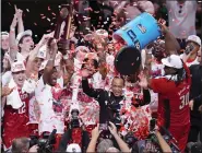  ?? LM OTERO — THE ASSOCIATED PRESS FILE ?? North Carolina State’s DJ Burns Jr., far right, dumps confetti on head coach Kevin Keatts following an Elite Eight game against Duke in the NCAA Tournament in Dallas.