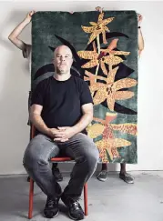  ?? MELISSA LYTTLE New York Times ?? Artist Jonas Wood poses in his Los Angeles studio with his rug ‘Yellow and Orange Orchid Clipping.’