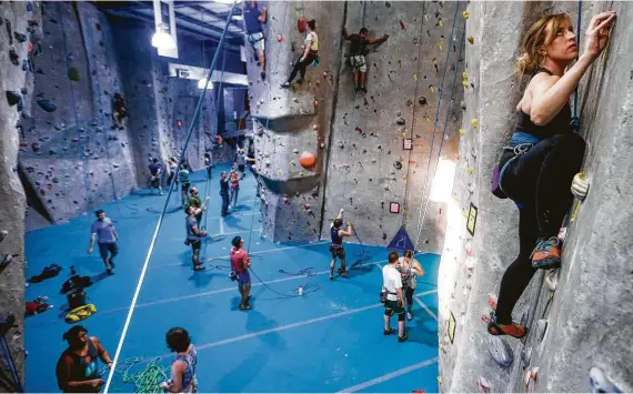  ?? Michael Ciaglo / Houston Chronicle ?? Leave all the stress of the day on the ground and hit the rock climbing walls at Texas Rock Gym.