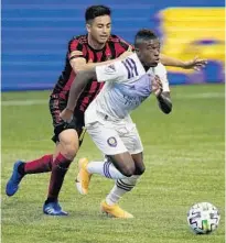  ?? BRYNN ANDERSON/AP ?? Orlando City midfielder Sebas Mendez (8) controls the ball ahead of Atlanta United midfielder Gonzalo Martinez (10) Aug. 29 in Atlanta.