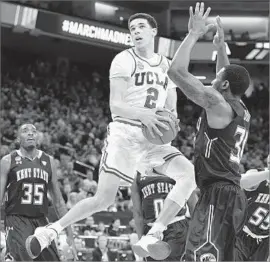  ?? Wally Skalij Los Angeles Times ?? LONZO BALL LOOKS to the basket as Kent State’s Kevin Zabo tries to stop him during the first half. UCLA took a 17-point edge and never gave up the lead.