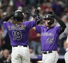  ?? David Zalubowski, The Associated Press ?? Colorado’s C.J. Cron, center, is congratula­ted as he crosses home plate by Charlie Blackmon after hitting a three-run home run in the seventh inning on Tuesday.