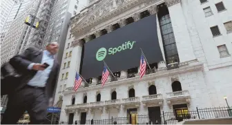  ?? AP PHOTO ?? BANNER DAY: A Spotify banner adorns the facade of the New York Stock Exchange, where it made its debut yesterday.