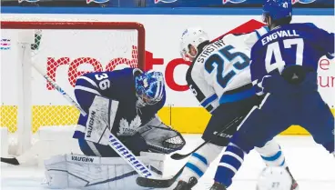  ?? JOHN E. SOKOLOWSKI / USA TODAY SPORTS ?? Winnipeg Jets forward Paul Stastny tries to get a rebound from Toronto Maple Leafs
goaltender Jack Campbell in action at Scotiabank Arena on Thursday.