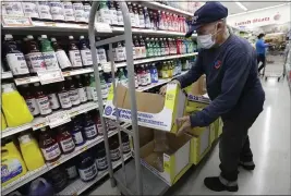  ?? WILFREDO LEE — THE ASSOCIATED PRESS ?? On Wednesday, Juan Santos stocks shelves at the Presidente Supermarke­t in the Little Havana neighborho­od of Miami.