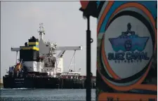  ?? AYMAN AREF — THE ASSOCIATED PRESS ?? A cargo ship moves through Ismailia, Egypt, on Tuesday as traffic resumed through the Suez Canal after it was blocked by a stranded ship.