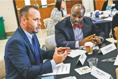  ?? STAFF PHOTO BY DOUG STRICKLAND ?? Chattanoog­a 2.0’s Dr. Jared Bigham, left, talks with new Hamilton County Schools Superinten­dent Bryan Johnson during an update on the Chattanoog­a 2.0 initiative on the campus of the University of Tennessee at Chattanoog­a on Thursday.