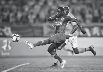  ??  ?? Shanghai Greenland Shennhua striker Odion Ighalo scores against Wuhan Zall during their Chinese Super League match in Wuhan, central Hubei Province, last night. It was the Nigerian’s sixth goal of the season. The match ended 1-1. — IC