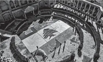  ?? IBRAHIM CHALHOUB/GETTY-AFP ?? Lebanon anniversar­y: An aerial view of a partially completed 300-square-yard Lebanese national flag made up from plastic bottles, caps, and empty bullet cartridges and set up by environmen­tal activists is seen Saturday at an open-air restaurant and wedding venue in Bnachii, Lebanon. Sunday is Lebanon’s independen­ce day.