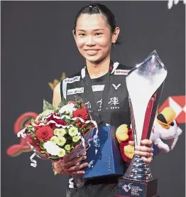  ?? — AP ?? All smiles: Tai Tzu-ying posing with the trophy after beating Saina Nehwal to win the women’s singles title in the Denmark Open badminton championsh­ip in Odense, Denmark, yesterday.