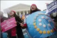  ?? CHARLES DHARAPAK — THE ASSOCIATED PRESS FILE ?? Margot Riphagen of New Orleans, La., wears a birth control pills costume during a protest in front of the U.S. Supreme Court in Washington.