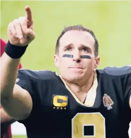  ?? BRYNN ANDERSON/AP ?? Saints quarterbac­k Drew Brees gestures to his family and fans after an NFL divisional round playoff game against the Buccaneers on Jan. 17 in New Orleans.