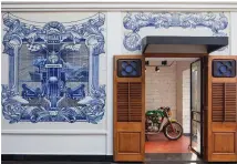  ?? Images by André J Fanthome ?? Hand-painted installati­ons adapted from azulejos, an Iberian tin-glazed, ceramic tilework technique, dot the facade of the Royal Enfield Garage Cafe