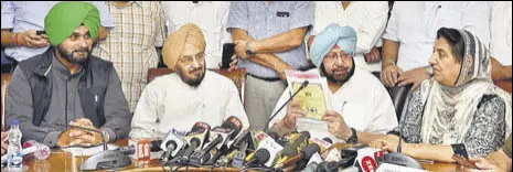  ?? HT PHOTO ?? (From left) Local bodies minister Navjot Sidhu, Punjab Mandi Board chairman Lal Singh, chief minister Capt Amarinder Singh and former CM Rajinder Kaur Bhattal at a press conference in Chandigarh on Monday.