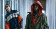  ?? FOCUS FEATURES ?? Colson Baker, aka, Machine Gun Kelly, left, and Ashton Sanders appear in a scene from the science-fiction drama “Captive State.”