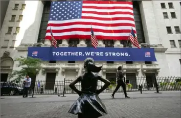  ?? Mark Lennihan/Associated Press ?? The Fearless Girl statue stands in front of the New York Stock Exchange on Thursday.