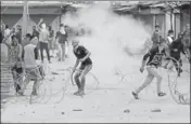  ?? AP ?? Protesters clash with security personnel in Srinagar on Friday.