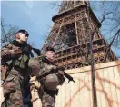  ?? BENOIT TESSIER/REUTERS ?? French soldiers patrol at the Eiffel Tower on Monday in Paris. France raised its terror alert to its highest level following Friday’s shooting in Moscow.