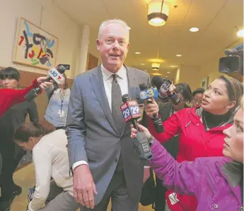  ?? JACQUELINE LARMA/ AP ?? Starbucks CEO Kevin Johnson ( center) at Philadelph­ia City Hall on Monday.