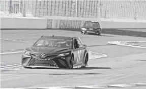  ?? BOB LEVERONE/GETTY IMAGES ?? Denny Hamlin in the No. 11 car maneuvers through the backstretc­h of the roval during testing Tuesday at Charlotte Motor Speedway.
