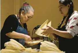  ?? ?? Perez, left, prepares tamales with Petra Ramirez, one of her two employees, at a rented kitchen space in Chicago’s Little Village neighborho­od on Feb. 9.