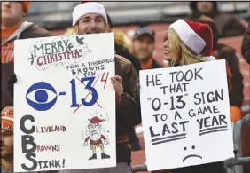  ?? Ap photo ?? Cleveland Browns fans hold up signs after the Baltimore Ravens defeated the Browns on Dec. 17.