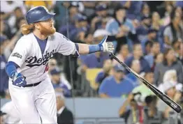  ?? Wally Skalij Los Angeles Times ?? Justin Turner hits a home run in the Dodgers’ 6-0 victory over the Cubs. The win gives the Dodgers a 2-1 lead in the best-of-seven National League Championsh­ip Series. The teams play again today at Dodger Stadium.