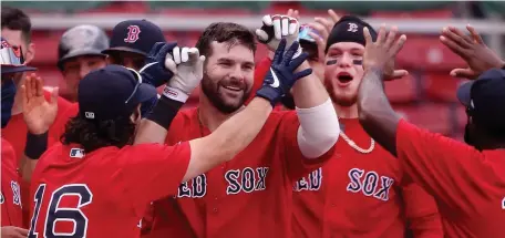  ?? NAncy LAnE PHotos / HERALd stAFF ?? WALK IT OFF: Mitch Moreland is mobbed by teammates after hitting a two-run home run in the bottom of the ninth on Sunday to give the Red Sox a 5-3 win over the Toronto Blue Jays.