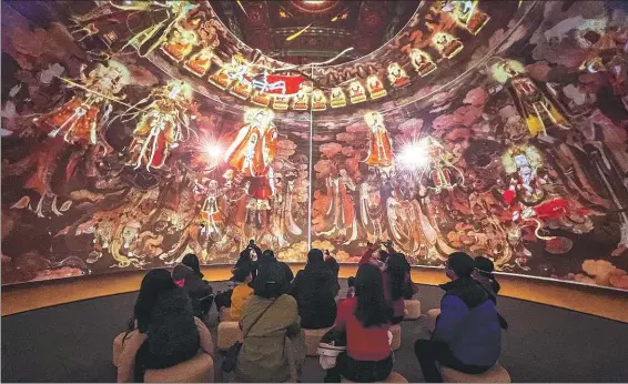  ?? PROVIDED TO CHINA DAILY ?? An audience watches a movie based on the murals of Fahai Temple in a 3D cinema in the art center in May 2023.