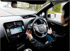  ?? (Toru Hanai/Reuters) ?? A NISSAN employee removes his hands from the steering wheel of an Easy Ride self-driving vehicle last week in Yokohama.