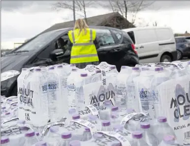  ??  ?? Work gets underway to fix the burst main in Bearsted, left. Bottled supplies were handed out to affected customers (file pic)