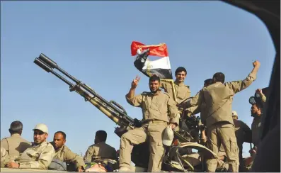  ?? Photo: AFP ?? Iraqi forces and mainly Shiite Muslim volunteers arrive in the predominan­tly Sunni Muslim city of Samarra, 124 kilometers from Baghdad on Wednesday, to protect the Shiite Muslim Al-Askari shrine which embraces the tombs of the 10th and 11th Imams, Ali...