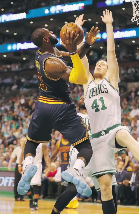  ?? — GETTY IMAGES FILES ?? LeBron James of the Cavaliers drives to the basket against Boston’s Kelly Olynyk during Game 1 of the East final. The Celtics threw seven different defenders at James but he still scored 38 points.