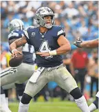  ?? BOB DONNAN/USA TODAY SPORTS ?? Cowboys quarterbac­k Dak Prescott looks to pass as Panthers defensive end Wes Horton moves in to apply pressure in the season opener.