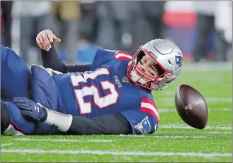  ?? ELISE AMENDOLA/AP PHOTO ?? New England Patriots quarterbac­k Tom Brady lands on the turf after being sacked by Kansas City Chiefs defensive end Chris Jones in the second half of Sunday’s game at Foxborough, Mass.