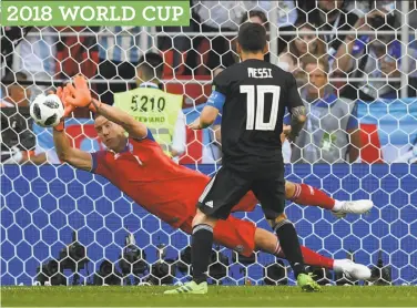  ?? Matthias Hangst / Getty Images ?? Iceland goalkeeper Hannes Halldorsso­n saves a second-half penalty try from Argentina’s Lionel Messi.