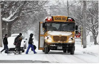  ?? TY GREENLEES / STAFF FILE ?? Students in Xenia board a bus to school on a snowy day in 2016. A change in Ohio law means schools no longer have to hold makeup days as soon as they hit their sixth “calamity day.”